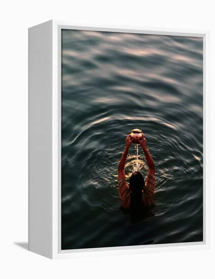 Woman Pouring Water During Morning Puja on Ganges, Varanasi, India-Anthony Plummer-Framed Premier Image Canvas