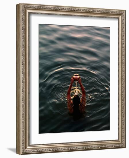 Woman Pouring Water During Morning Puja on Ganges, Varanasi, India-Anthony Plummer-Framed Photographic Print