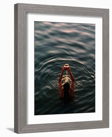 Woman Pouring Water During Morning Puja on Ganges, Varanasi, India-Anthony Plummer-Framed Photographic Print