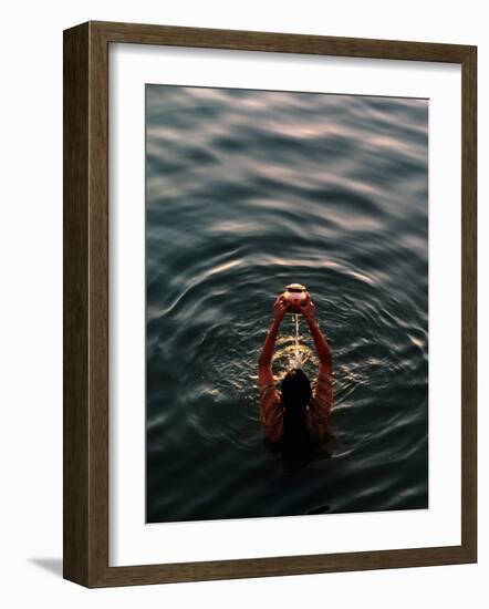 Woman Pouring Water During Morning Puja on Ganges, Varanasi, India-Anthony Plummer-Framed Photographic Print