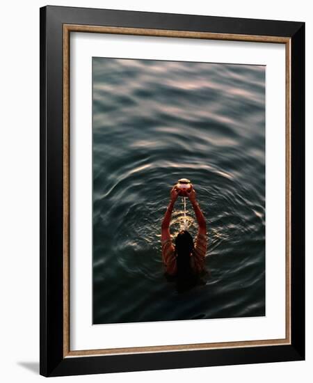 Woman Pouring Water During Morning Puja on Ganges, Varanasi, India-Anthony Plummer-Framed Photographic Print