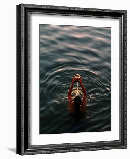 Woman Pouring Water During Morning Puja on Ganges, Varanasi, India-Anthony Plummer-Framed Photographic Print