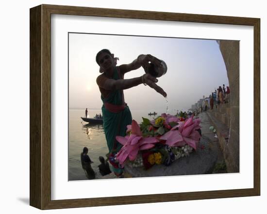 Woman Pouring Water Over Flowers on an Altar as a Religious Ritual, Varanasi, India-Eitan Simanor-Framed Photographic Print