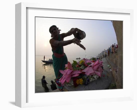 Woman Pouring Water Over Flowers on an Altar as a Religious Ritual, Varanasi, India-Eitan Simanor-Framed Photographic Print