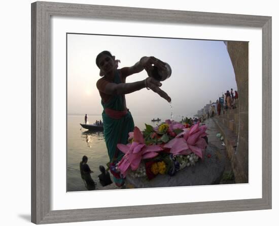 Woman Pouring Water Over Flowers on an Altar as a Religious Ritual, Varanasi, India-Eitan Simanor-Framed Photographic Print