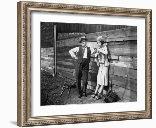 Woman Practicing Her Trumpet While a Man is Standing Next to Her Looking Annoyed-null-Framed Photo