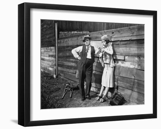 Woman Practicing Her Trumpet While a Man is Standing Next to Her Looking Annoyed-null-Framed Photo