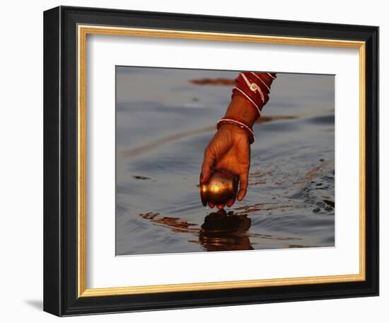 Woman Praying on the Banks of the River Ganges Fills Water into a Copper Vessel for a Ritual-null-Framed Photographic Print