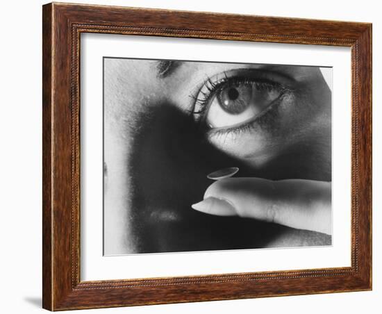 Woman Preparing to Insert Contact Lens Into Her Eye-Henry Groskinsky-Framed Photographic Print