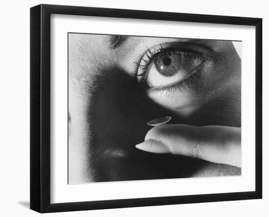 Woman Preparing to Insert Contact Lens Into Her Eye-Henry Groskinsky-Framed Photographic Print