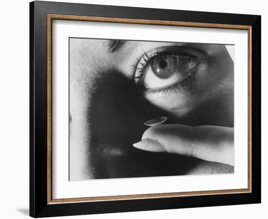 Woman Preparing to Insert Contact Lens Into Her Eye-Henry Groskinsky-Framed Photographic Print