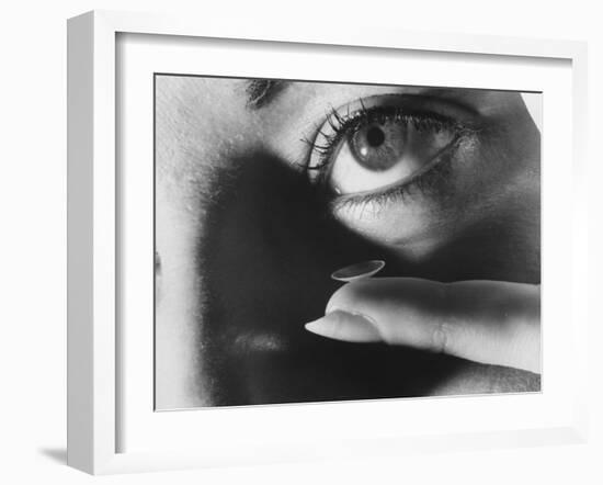 Woman Preparing to Insert Contact Lens Into Her Eye-Henry Groskinsky-Framed Photographic Print