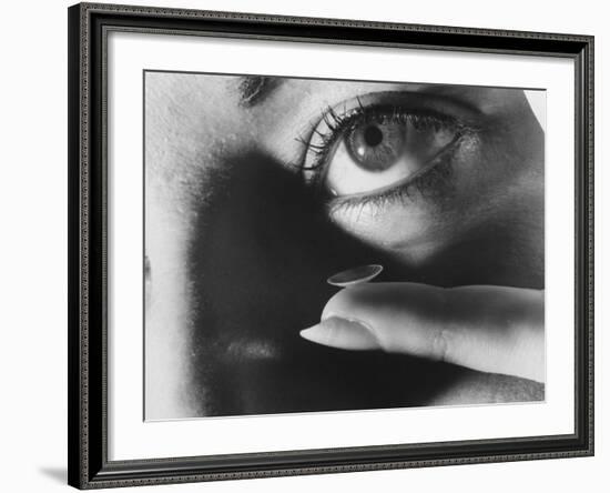 Woman Preparing to Insert Contact Lens Into Her Eye-Henry Groskinsky-Framed Photographic Print