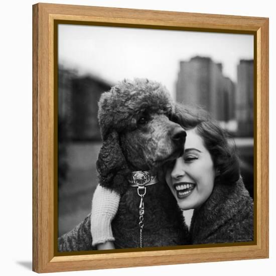 Woman Profiling a Big Smile While Adoring Her Poodle Wearing Large Swiss Watch on Dog Collar-Yale Joel-Framed Premier Image Canvas