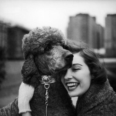 Woman Profiling a Big Smile While Adoring Her Poodle Wearing