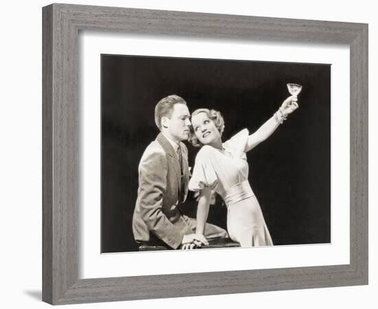 Woman Proposing a Toast to Hesitant Man-null-Framed Photo