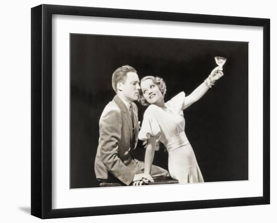 Woman Proposing a Toast to Hesitant Man-null-Framed Photo