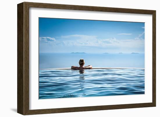 Woman Relaxing in Infinity Swimming Pool on Vacation-Splendens-Framed Photographic Print
