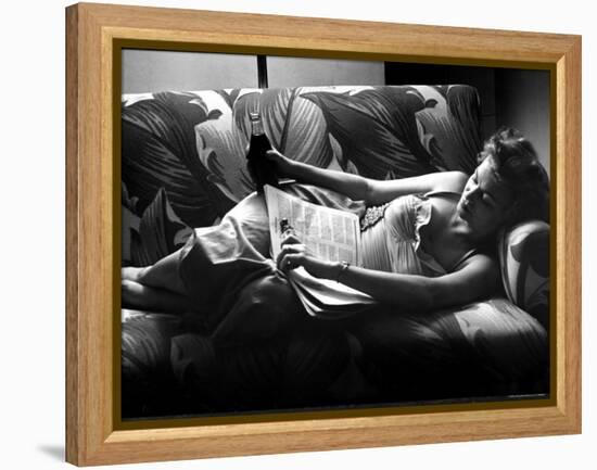 Woman Relaxing on Sofa, Reading and Drinking a Coke-Nina Leen-Framed Premier Image Canvas