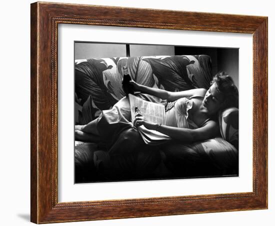 Woman Relaxing on Sofa, Reading and Drinking a Coke-Nina Leen-Framed Photographic Print