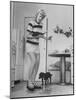 Woman Scrubbing Kitchen Floor with Brushes Attached to Her Feet-Allan Grant-Mounted Photographic Print