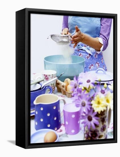 Woman Sieving Flour into a Bowl, Crockery & Eggs in Front-Linda Burgess-Framed Premier Image Canvas