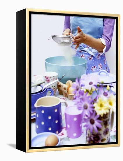 Woman Sieving Flour into a Bowl, Crockery & Eggs in Front-Linda Burgess-Framed Premier Image Canvas