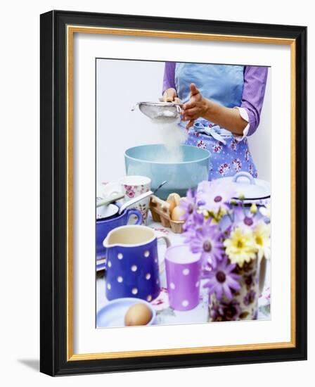 Woman Sieving Flour into a Bowl, Crockery & Eggs in Front-Linda Burgess-Framed Photographic Print