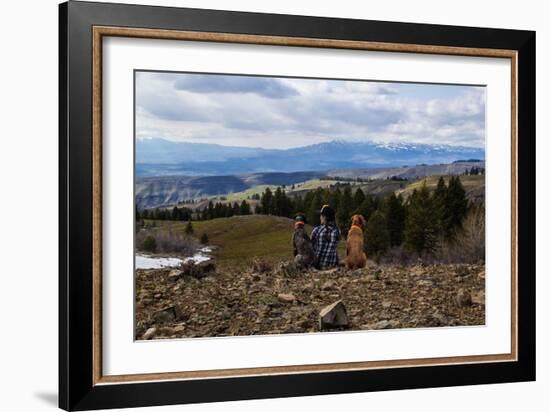 Woman Sits Next To Her Two Dogs Looking Out Into Idaho's Mountainous Landscape-Hannah Dewey-Framed Photographic Print