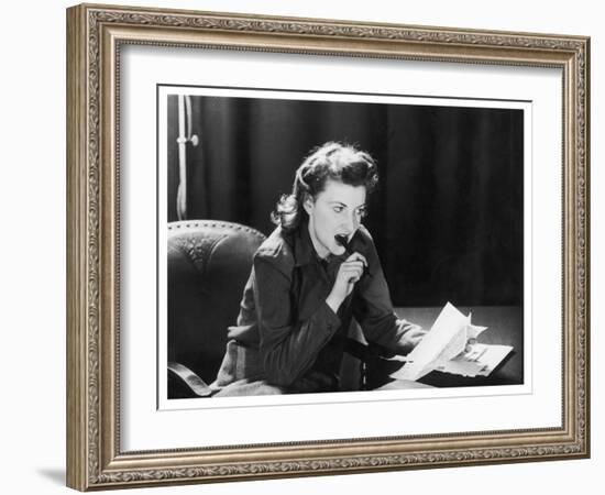 Woman Sits with Her Pen in Her Mouth Whilst Thinking About What She Should Write in Her Letter-null-Framed Art Print