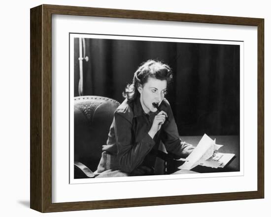 Woman Sits with Her Pen in Her Mouth Whilst Thinking About What She Should Write in Her Letter-null-Framed Art Print
