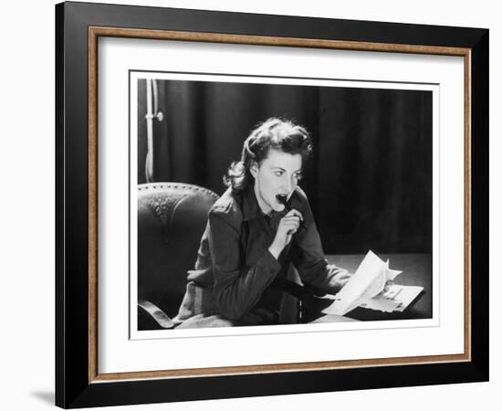 Woman Sits with Her Pen in Her Mouth Whilst Thinking About What She Should Write in Her Letter-null-Framed Art Print