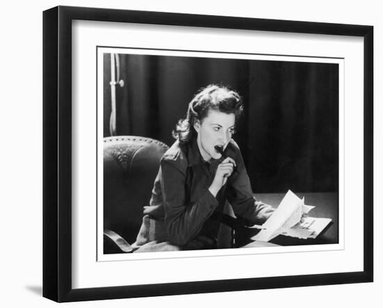 Woman Sits with Her Pen in Her Mouth Whilst Thinking About What She Should Write in Her Letter-null-Framed Art Print