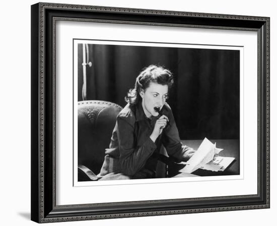 Woman Sits with Her Pen in Her Mouth Whilst Thinking About What She Should Write in Her Letter-null-Framed Art Print