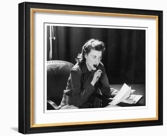 Woman Sits with Her Pen in Her Mouth Whilst Thinking About What She Should Write in Her Letter-null-Framed Art Print