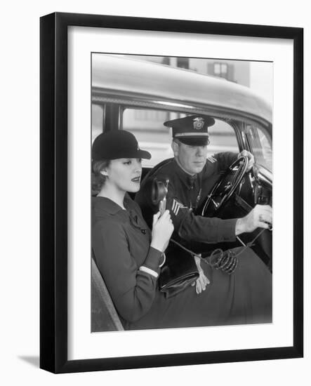Woman Sitting Next to a Policeman in His Car Holding a Microphone in Her Hand-null-Framed Photo