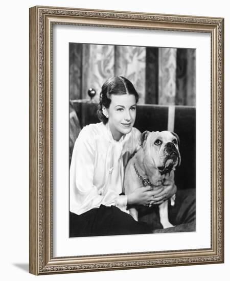 Woman Sitting on a Sofa Holding Her Bulldog-null-Framed Photo