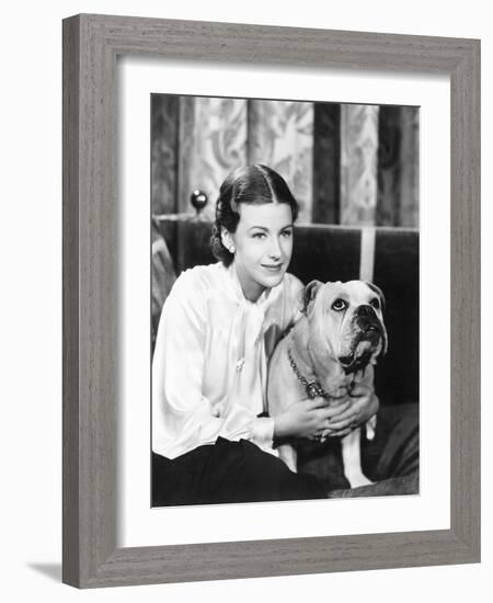 Woman Sitting on a Sofa Holding Her Bulldog-null-Framed Photo