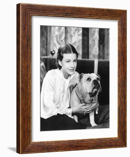 Woman Sitting on a Sofa Holding Her Bulldog-null-Framed Photo