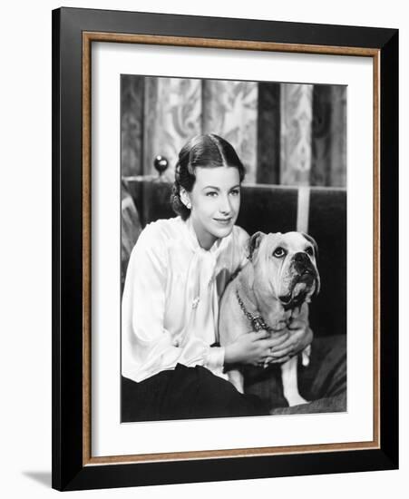 Woman Sitting on a Sofa Holding Her Bulldog-null-Framed Photo