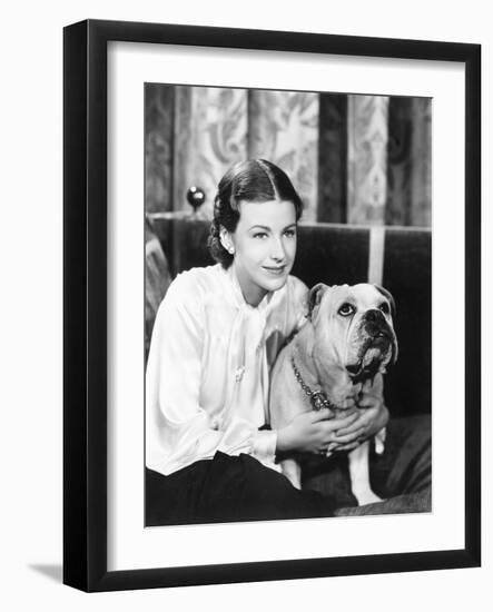 Woman Sitting on a Sofa Holding Her Bulldog-null-Framed Photo