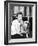 Woman Sitting on a Sofa Holding Her Bulldog-null-Framed Photo