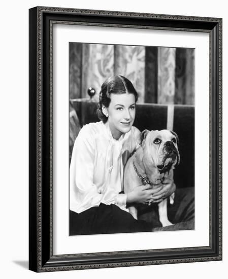 Woman Sitting on a Sofa Holding Her Bulldog-null-Framed Photo