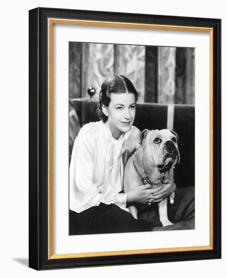 Woman Sitting on a Sofa Holding Her Bulldog-null-Framed Photo