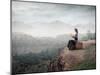 Woman Sitting On A Suitcase And Reading A Book With Landscape On The Background-olly2-Mounted Art Print