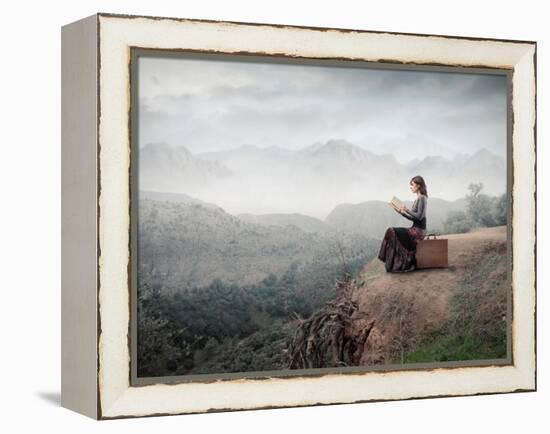 Woman Sitting On A Suitcase And Reading A Book With Landscape On The Background-olly2-Framed Stretched Canvas