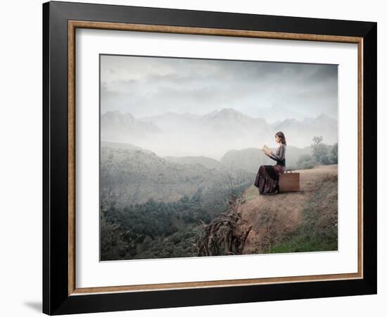 Woman Sitting On A Suitcase And Reading A Book With Landscape On The Background-olly2-Framed Premium Giclee Print