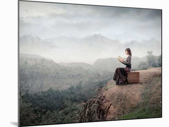 Woman Sitting On A Suitcase And Reading A Book With Landscape On The Background-olly2-Mounted Premium Giclee Print