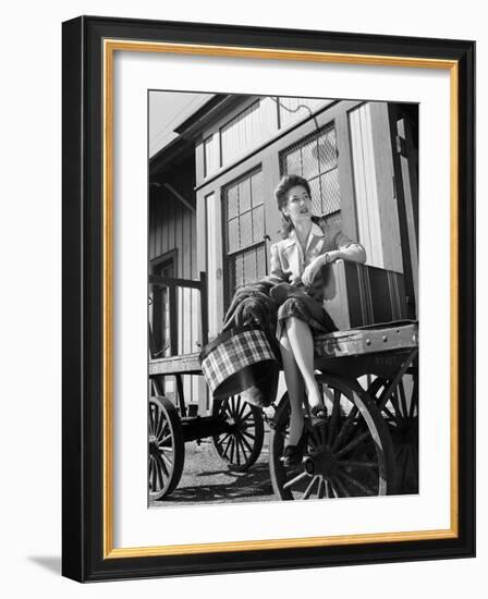 Woman Sitting on Luggage Trolley-Philip Gendreau-Framed Photographic Print