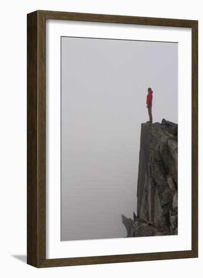 Woman Stands Looking Out Into The Fog On Top Of A Cliff In The North Cascades, Wa-Hannah Dewey-Framed Photographic Print